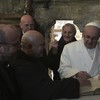 Il papa firma il libro dei visitatori attorniato dai francescani che reggono il santuario e dal nuovo vescovo di Rieti mons. Domenico Pompili