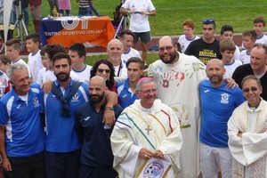 Il vescovo Claudio insieme a don Federico Fabris tra la Nazionale amputati dopo la celebrazione della messa